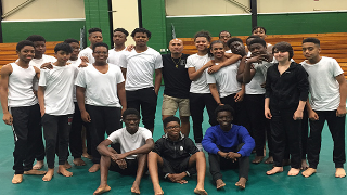 Alumnus Aaron Ramos, center, with his 8th grade all-boys dance class