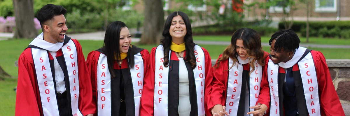 5 graduates laughing