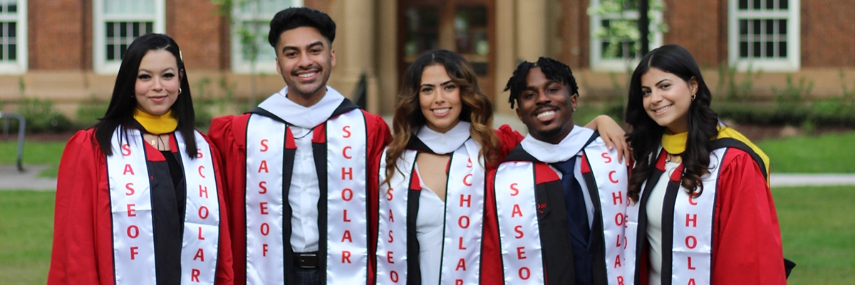 5 graduates smiling